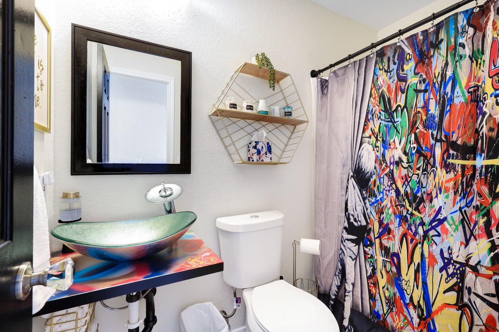 The full bath on the main level includes a chic vanity & walk-in shower