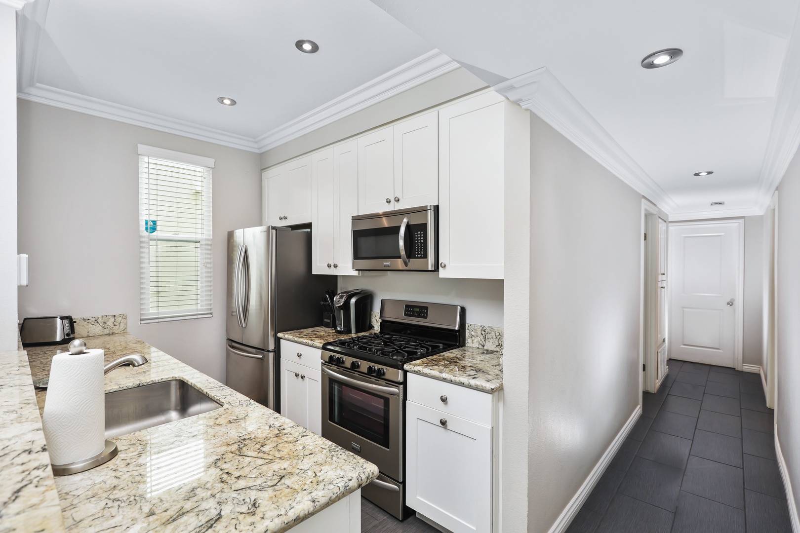 The open, airy kitchen offers ample space & every home comfort