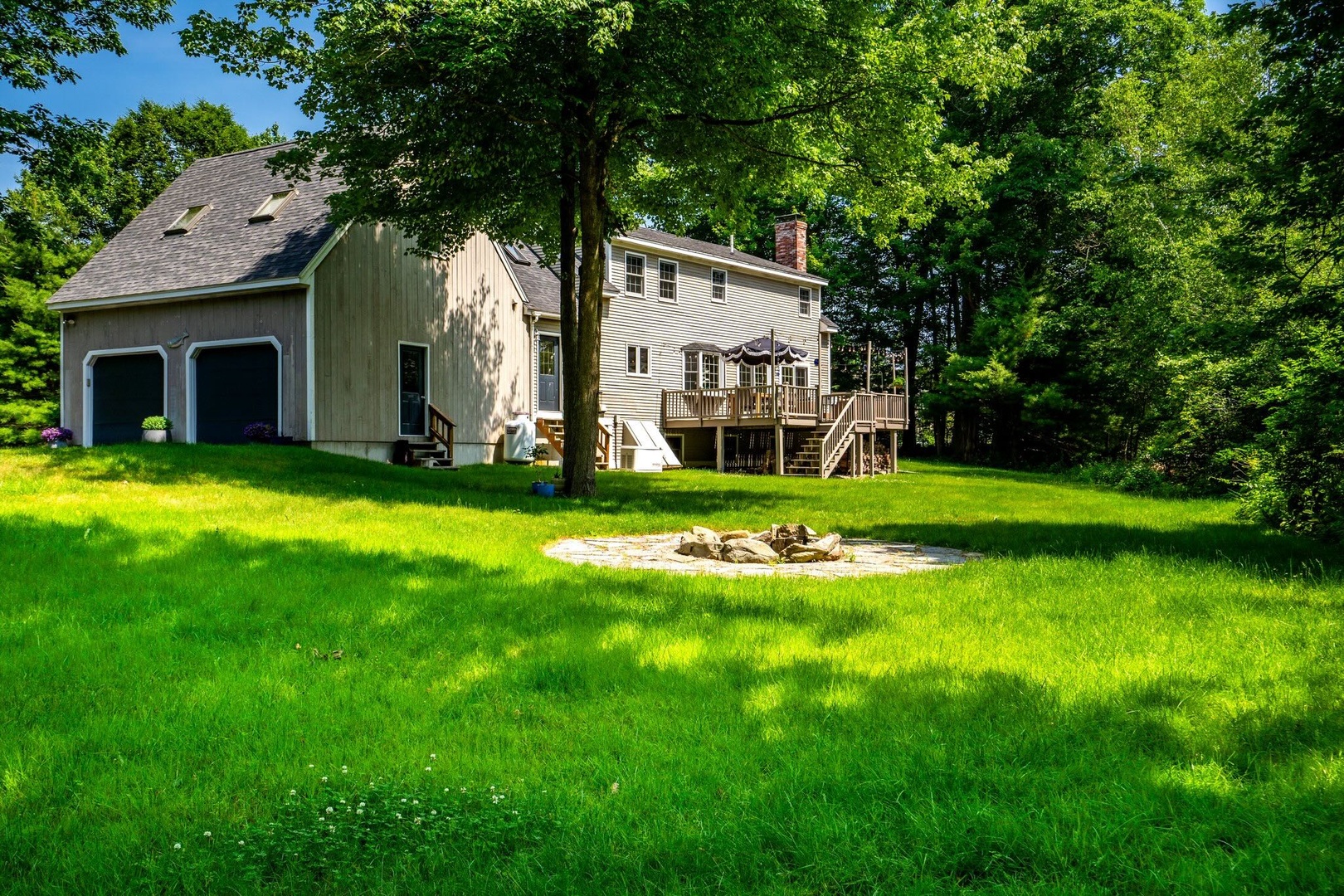 The sunny back yard offers ample space for relaxation