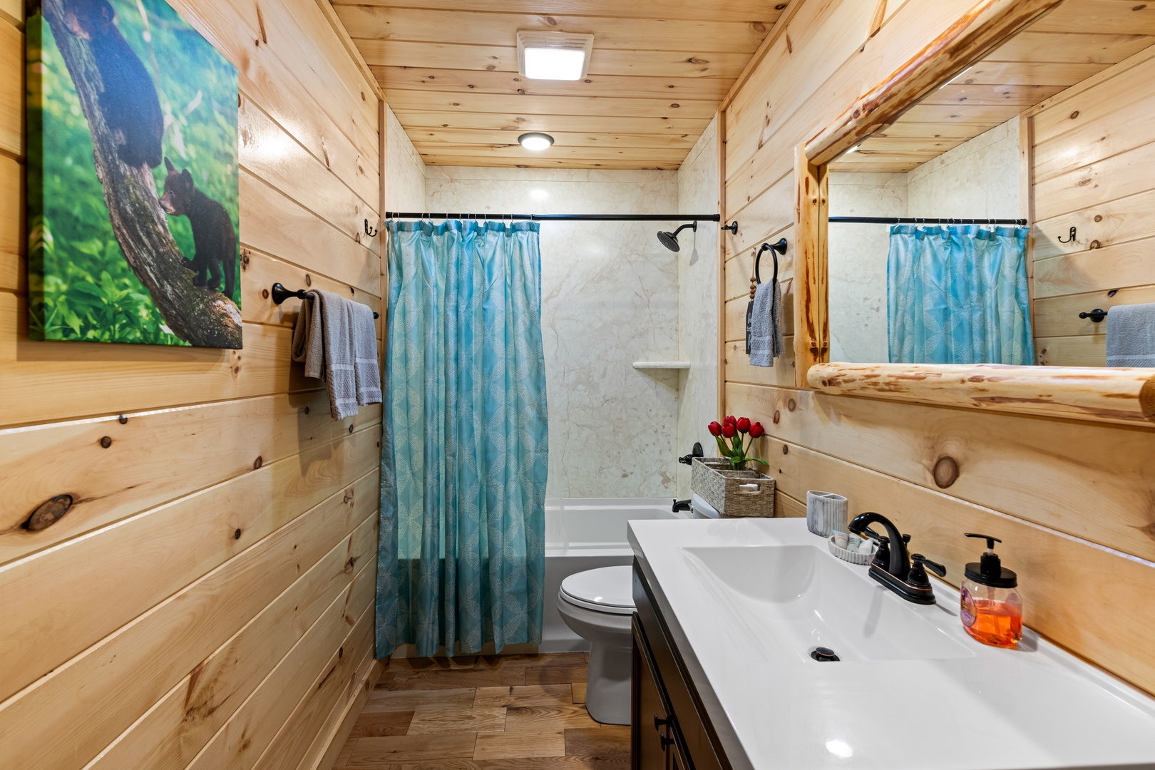 A single vanity & shower/tub combo await in the second ensuite bath