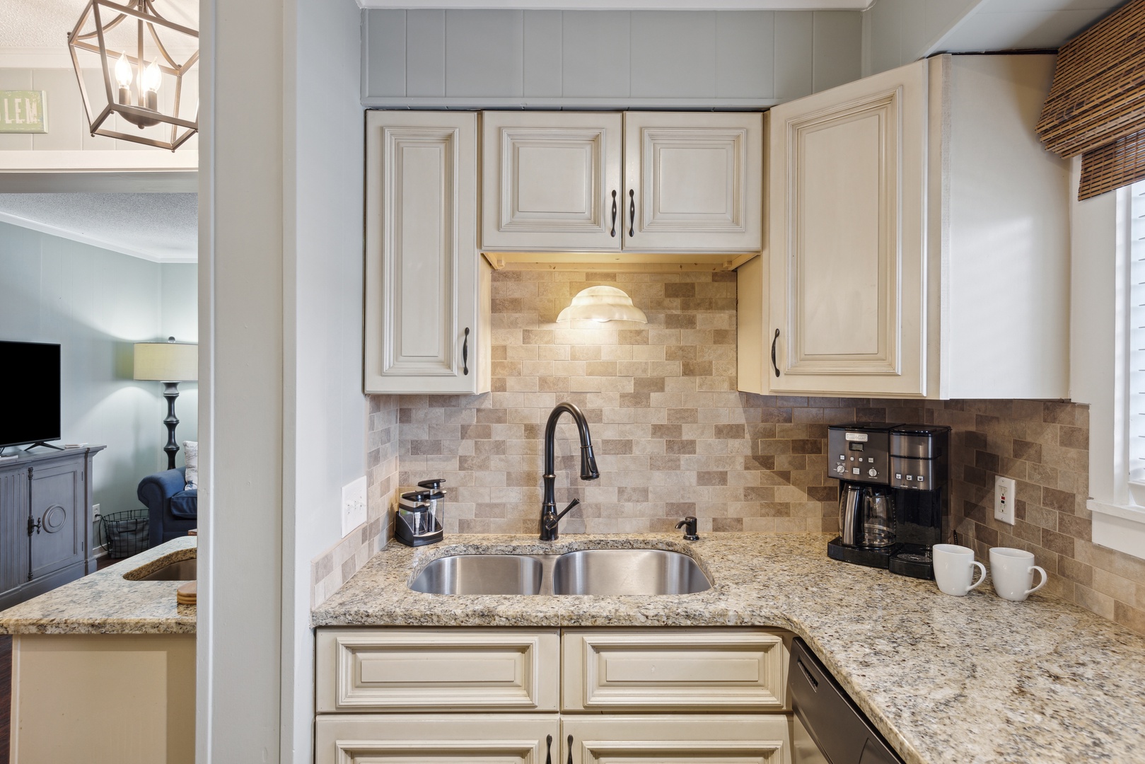 The elegant kitchen offers ample space & all the comforts of home
