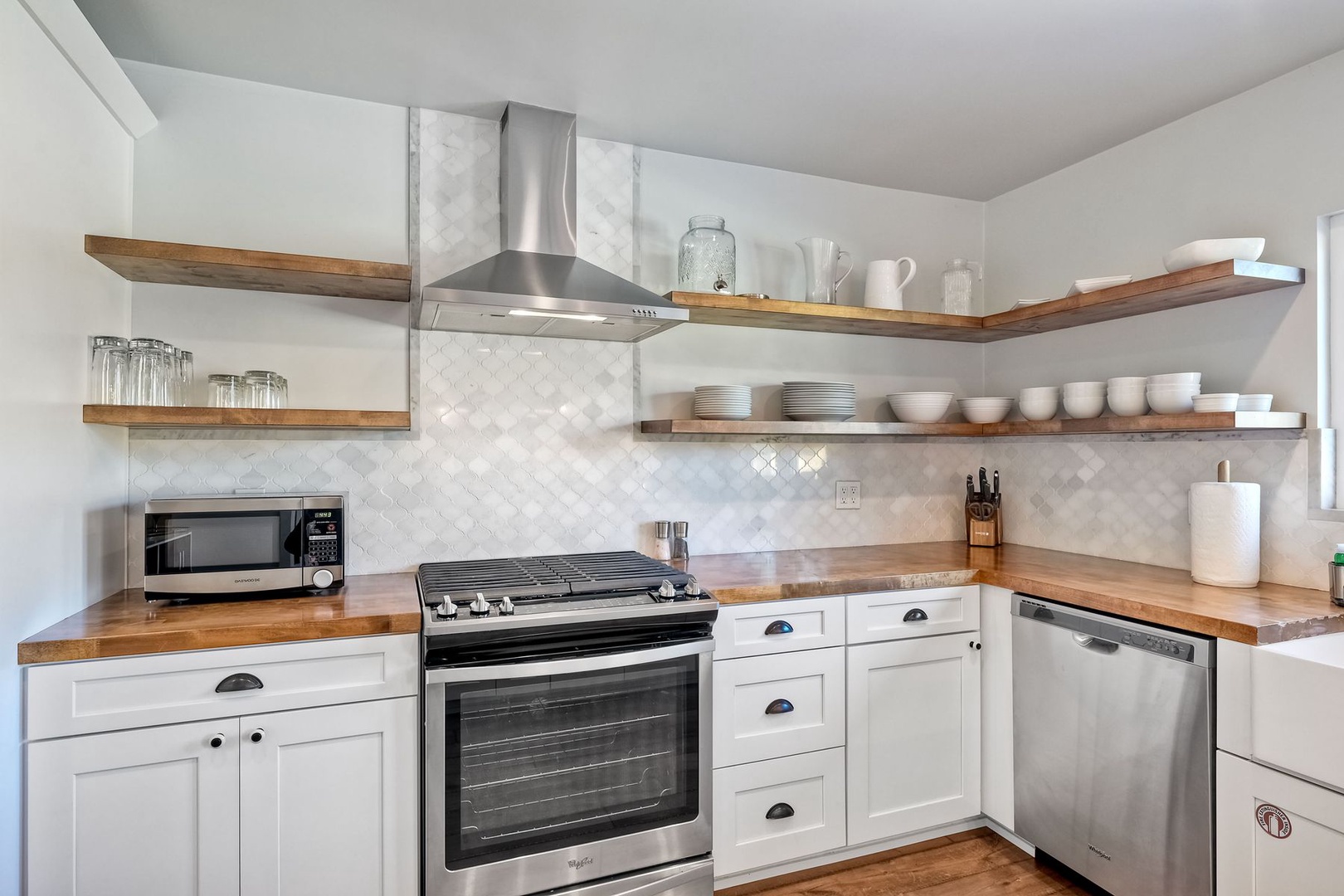 The airy kitchen is spacious & offers all the comforts of home