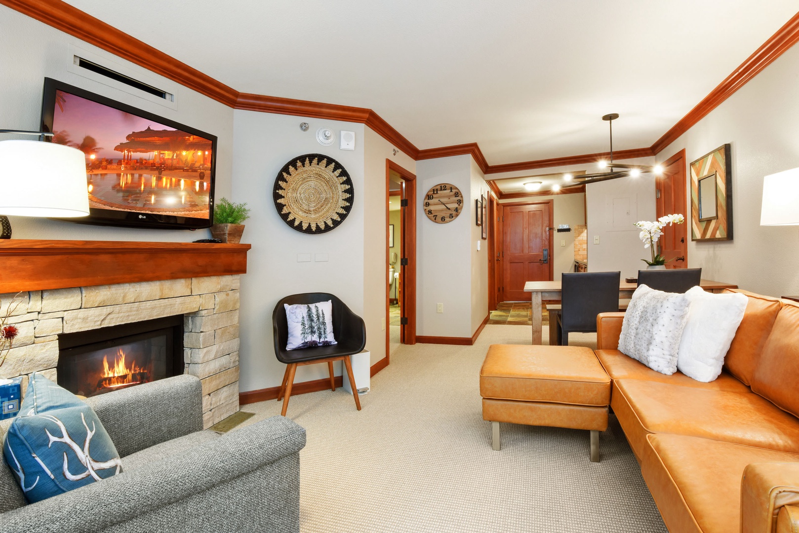 Newly remodeled hotel style living room with fireplace, TV