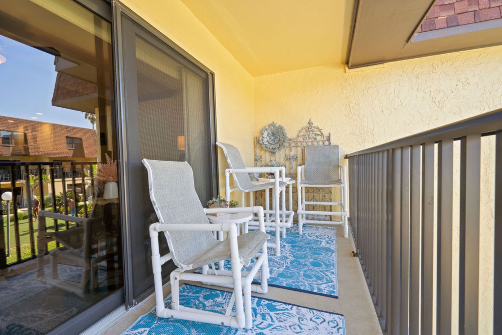 Private balcony with outdoor seating and pool views