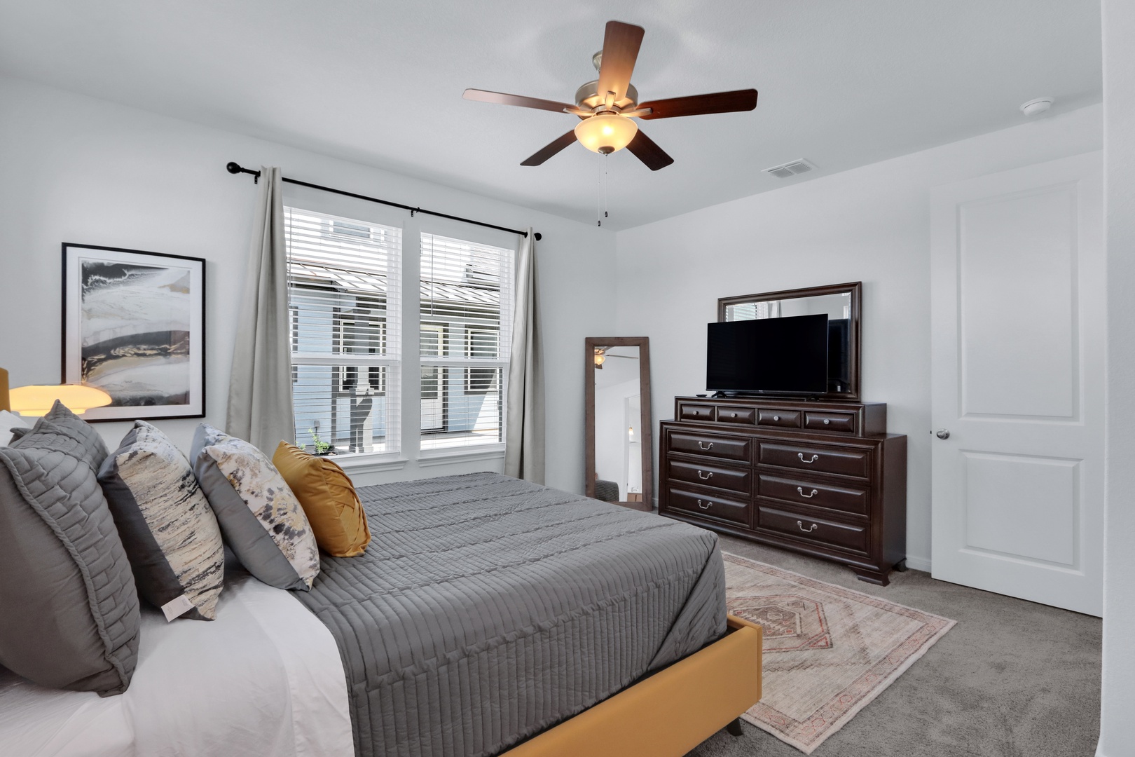 This 1st-floor queen suite boasts a private ensuite, walk-in closet, & Smart TV