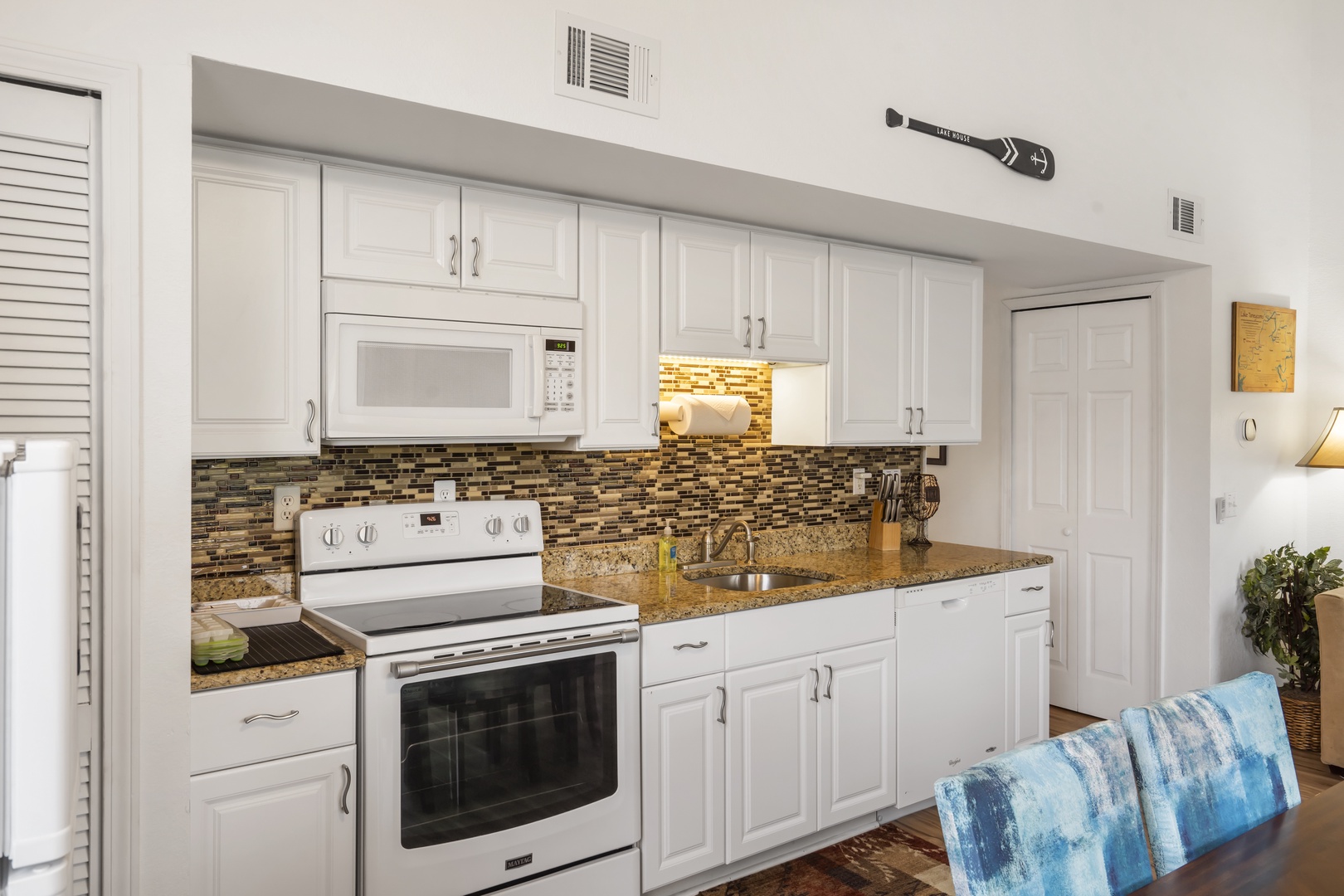 The sleek, efficient kitchen offers ample space & all the comforts of home