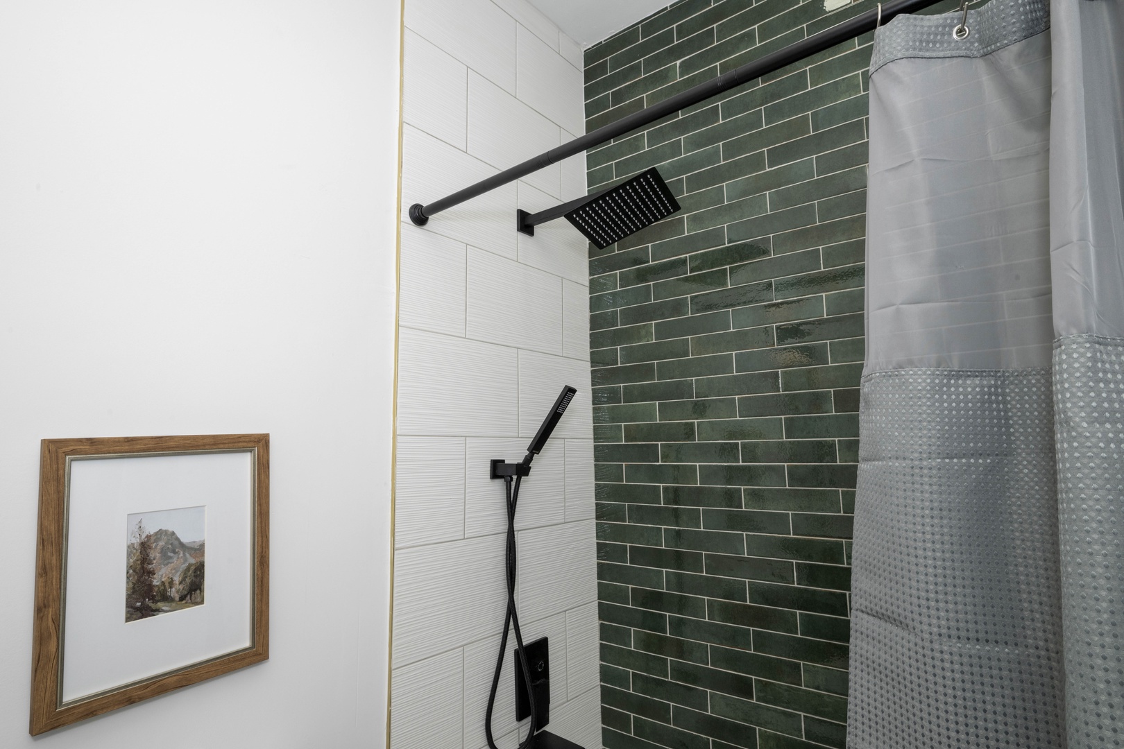 This 2nd-floor full bath showcases a single vanity & tiled shower/tub combo