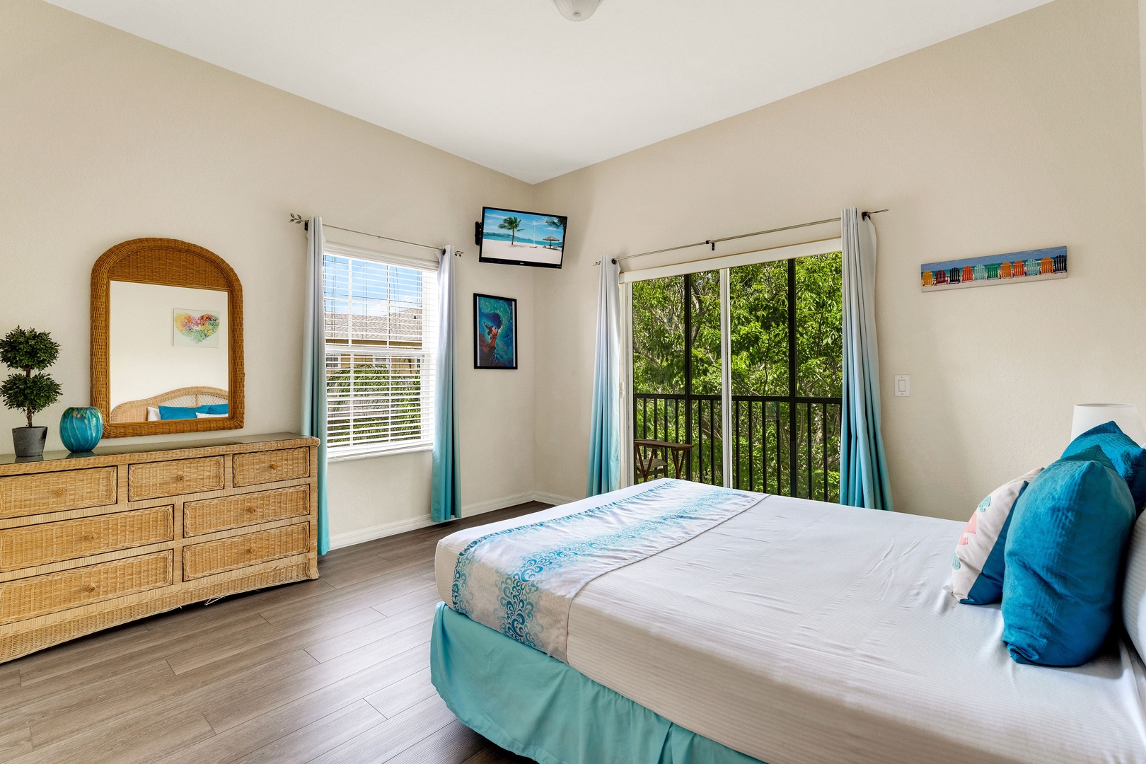 The tranquil queen suite offers an attached bath, TV, & balcony access