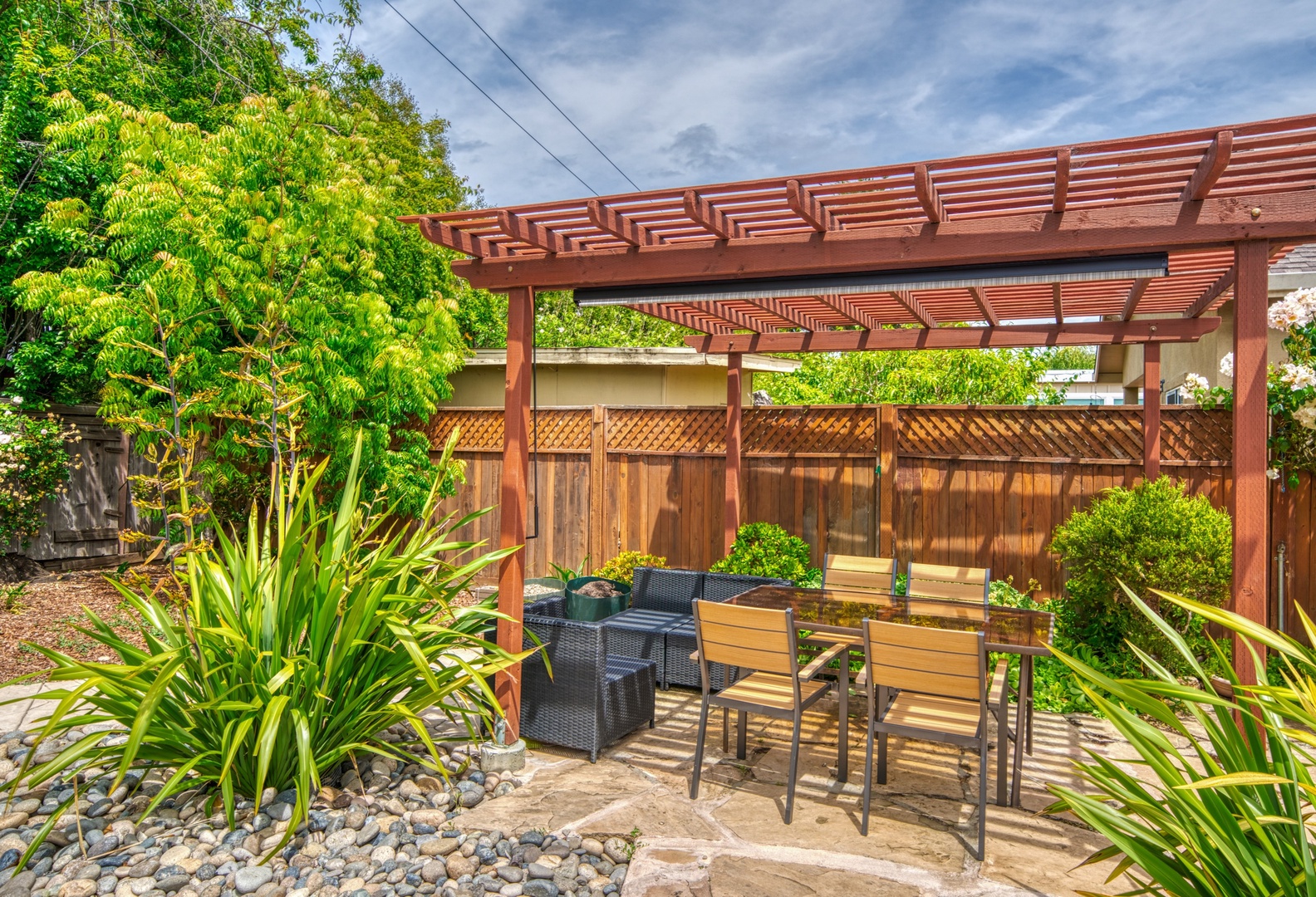 Lounge the day away or enjoy a stroll in the tranquil backyard oasis