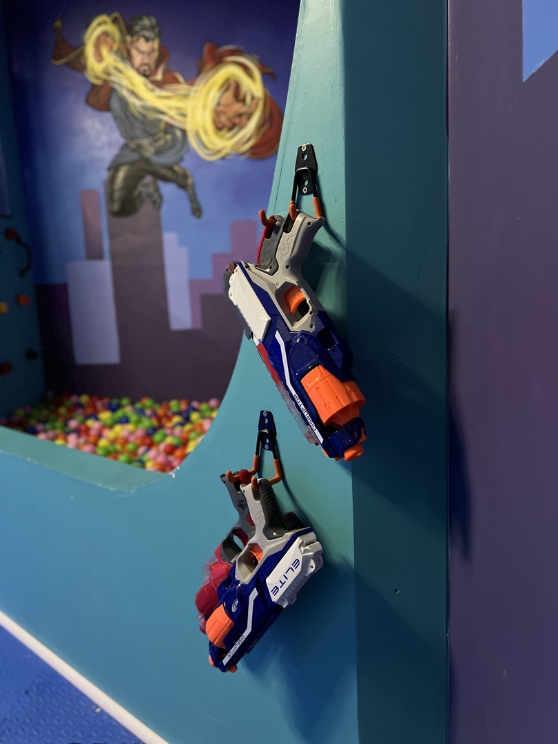 Avengers garage playroom with slide, ball pit, rock climbing wall and Nerf guns