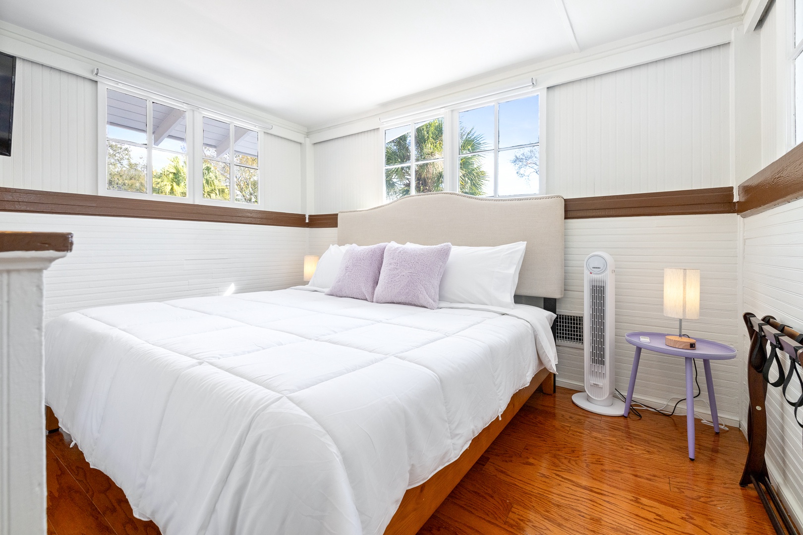 The sunny king bedroom on the 2nd level offers a convenient desk & Smart TV