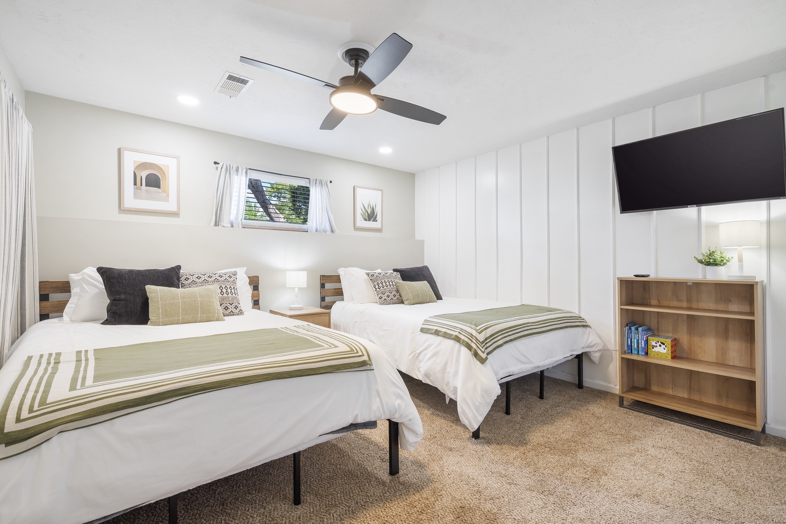 The first bedroom sanctuary offers a pair of cozy queen beds & Smart TV