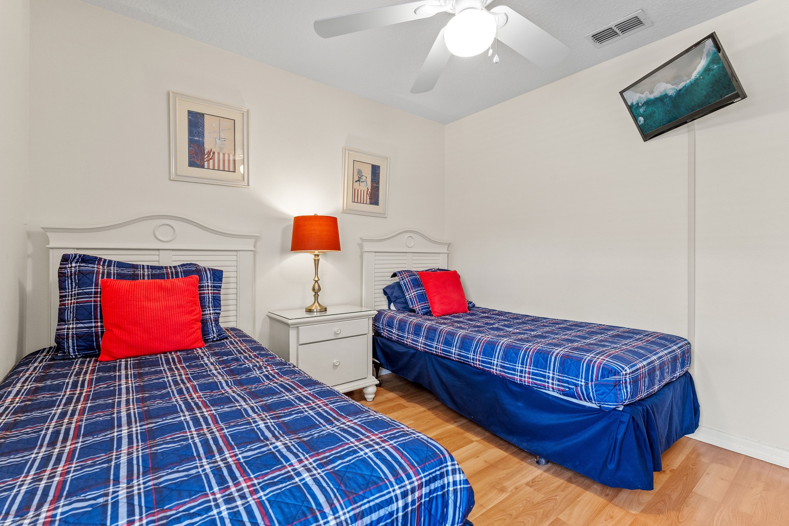 Double twin bedroom featuring a ceiling fan for added comfort