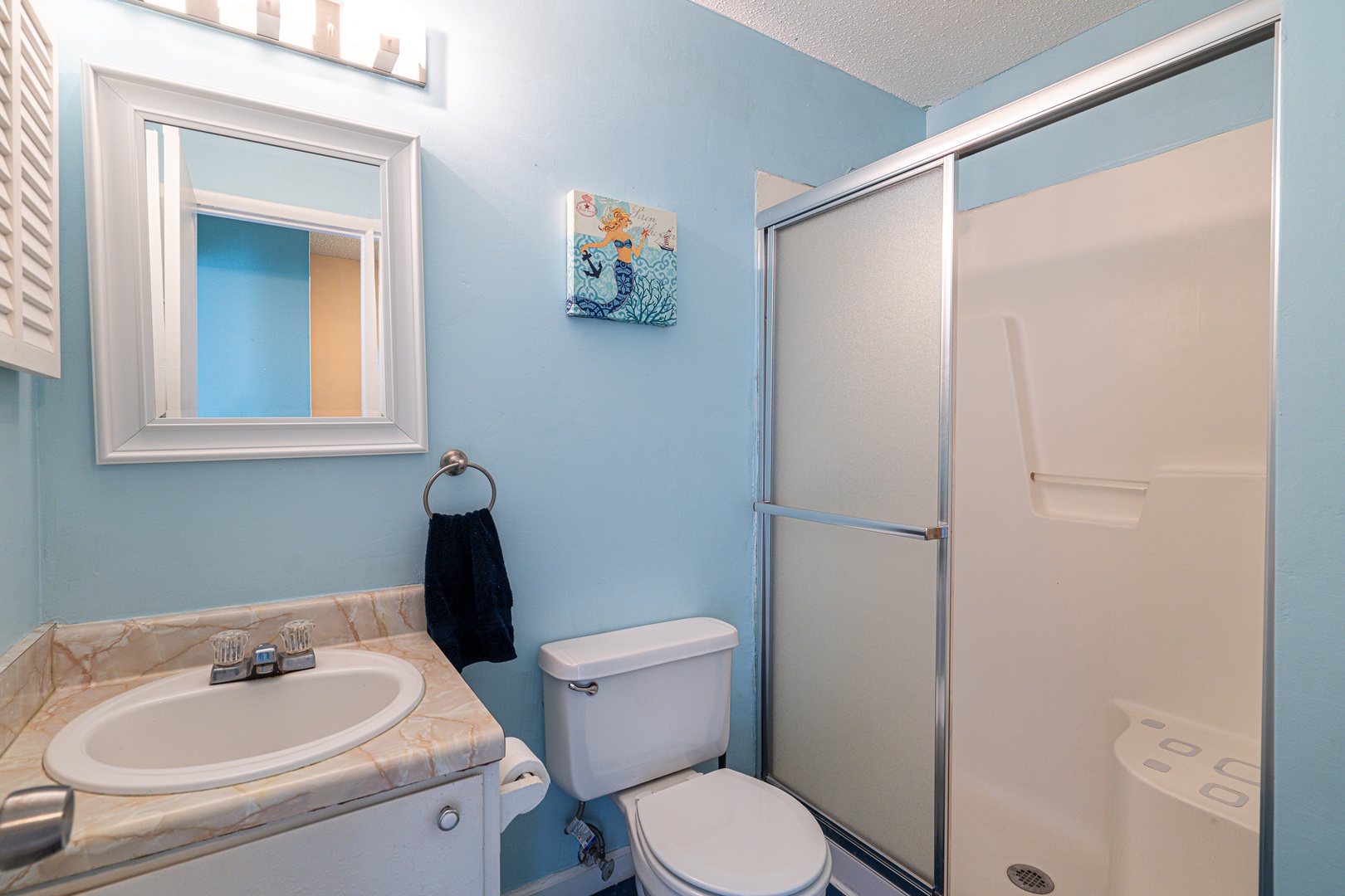This full bath on the second floor offers a single vanity & glass shower