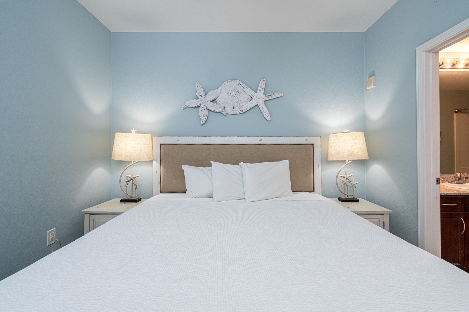 The coastal chic suite boasts a plush king bed, private ensuite, & TV