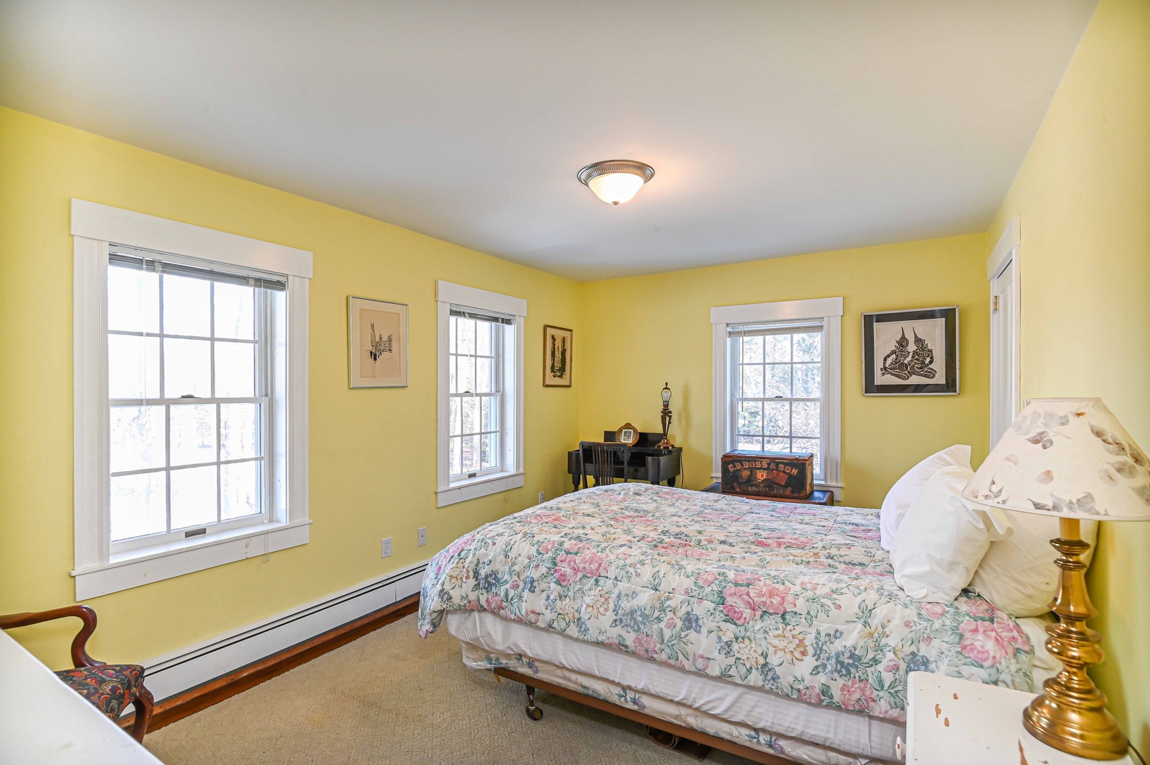 This cheerful second-floor bedroom features a cozy queen-sized bed
