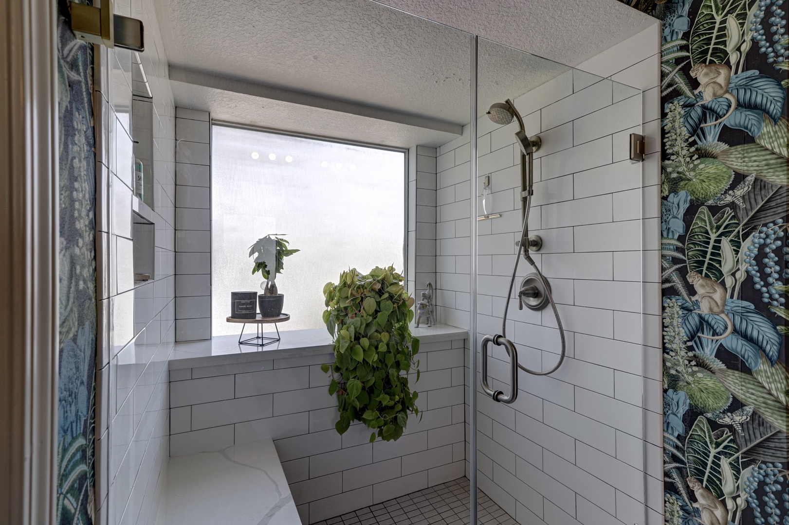 This ensuite features a double vanity, walk-in closet, & luxurious glass shower
