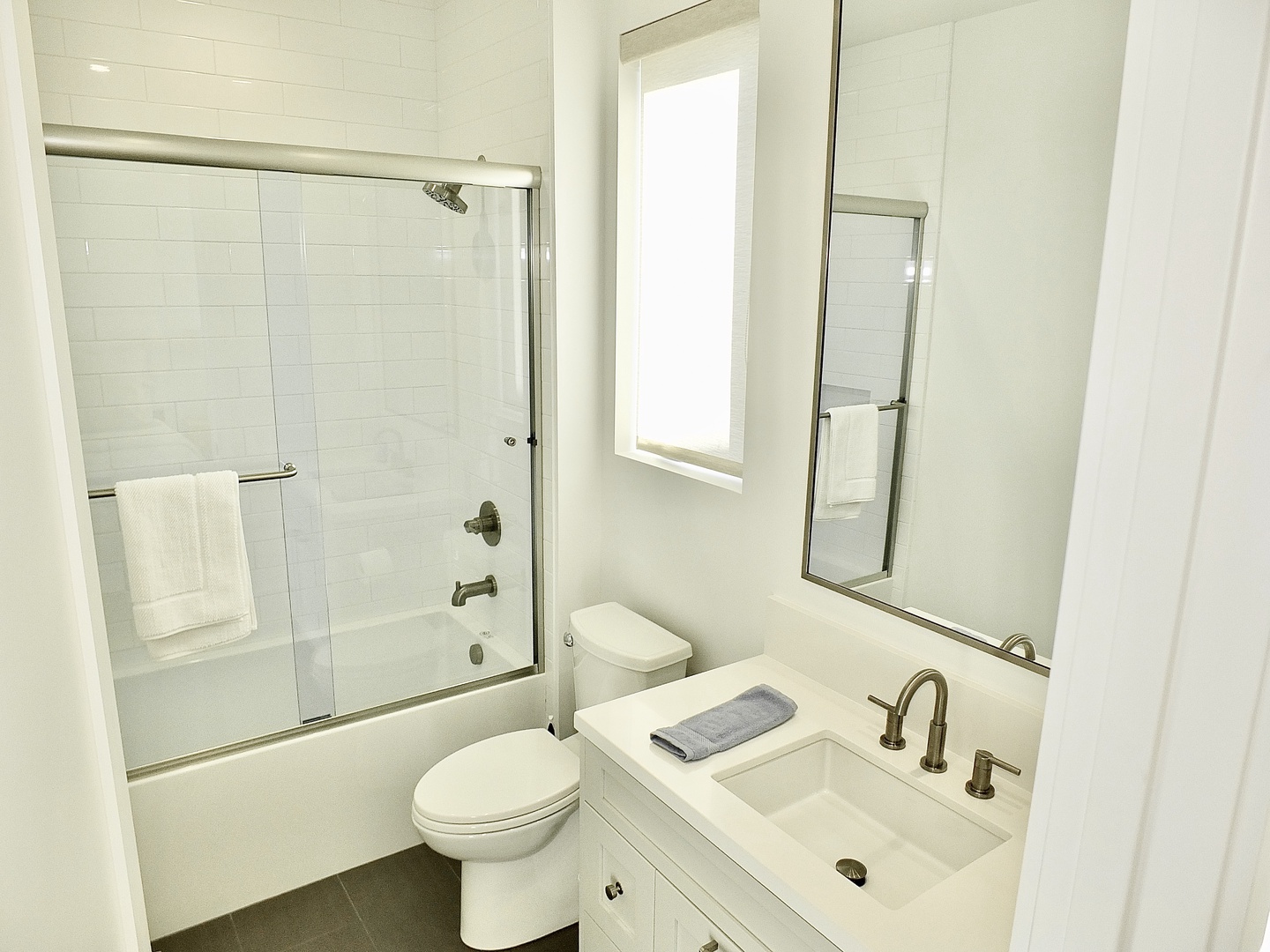 A single vanity & shower/tub combo await in this ensuite bath
