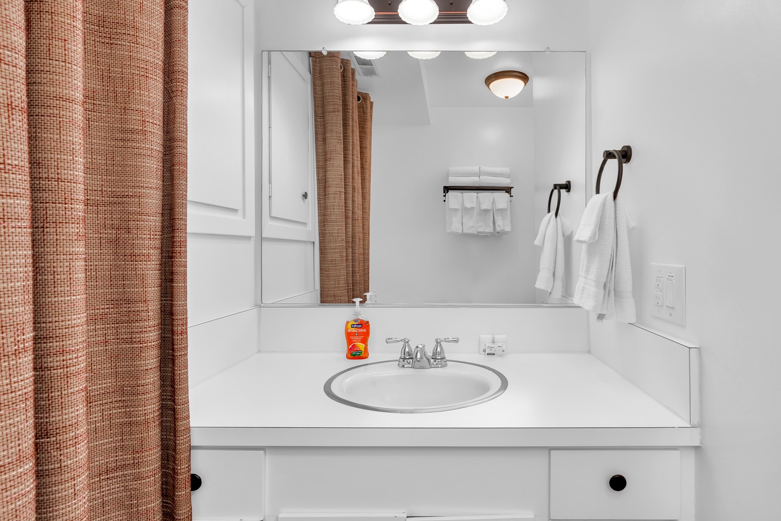 This 1st-floor full bath offers a single vanity & shower