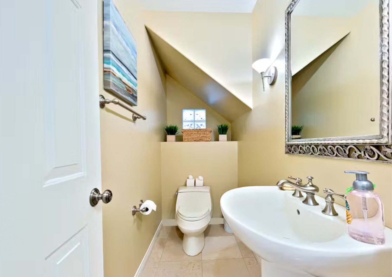 The downstairs half bathroom includes a pedestal sink