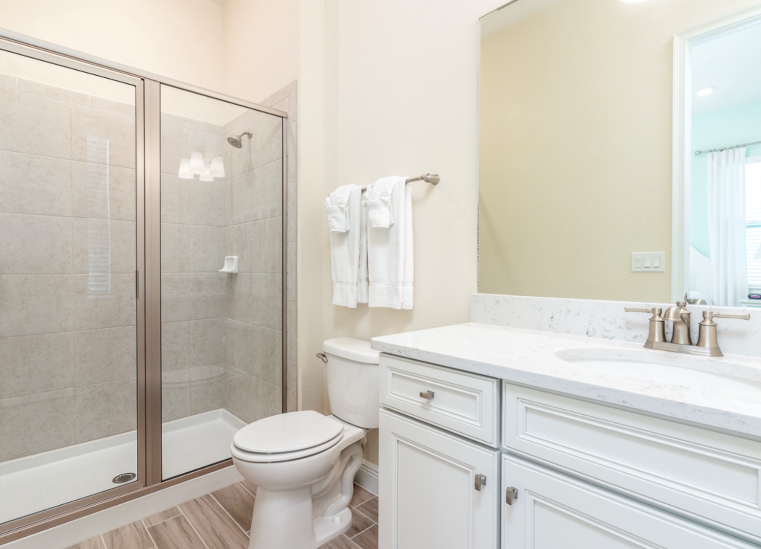 A single vanity & walk-in shower await in this ensuite bath