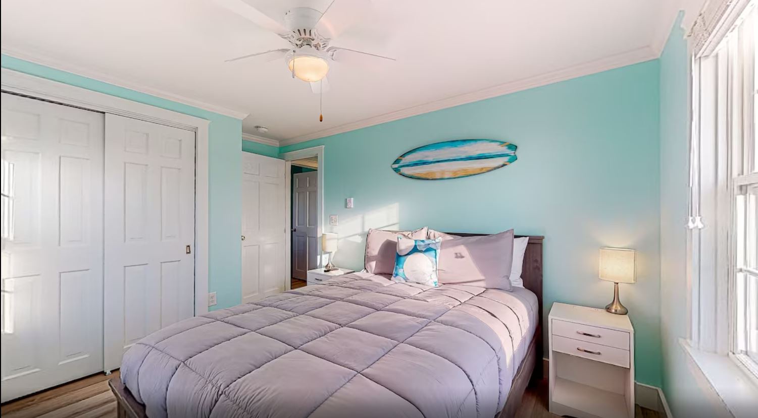 This bedroom features a full bed, smart TV & ceiling fan