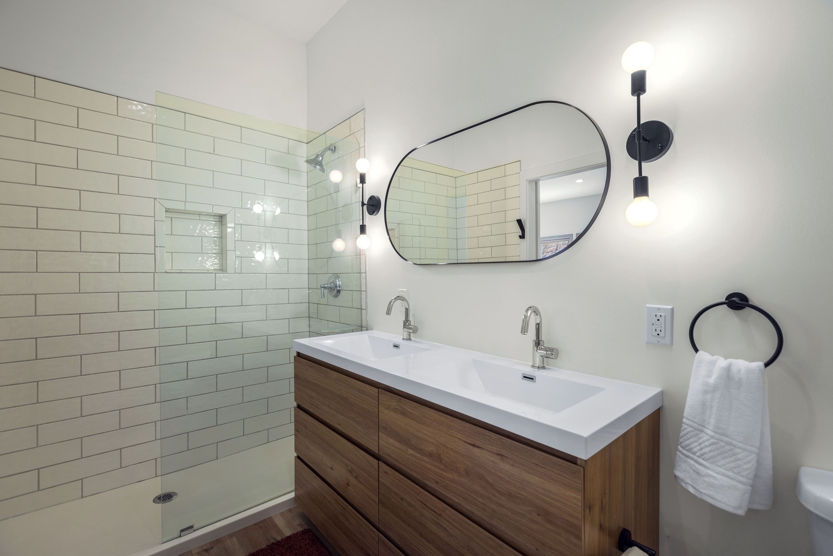 The second full bathroom includes a double vanity & sap like glass-shower