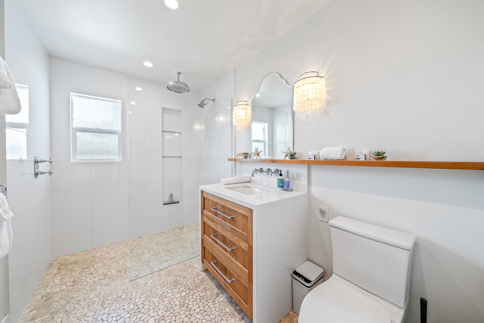 The full bathroom includes a chic single vanity & glass walk-in shower