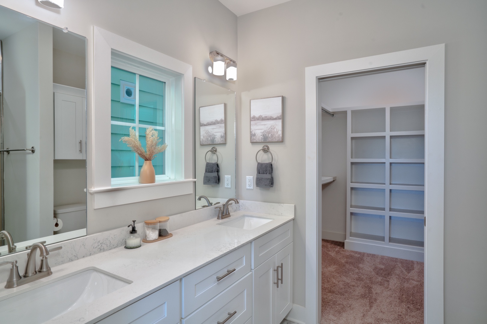 This 3rd floor ensuite includes a dual vanity, glass shower, & walk-in closet