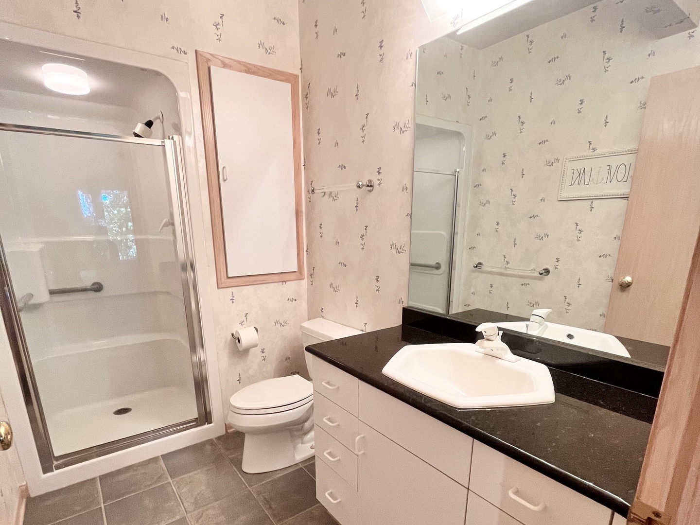 This walk-out lower-level en suite offers a single vanity & glass shower