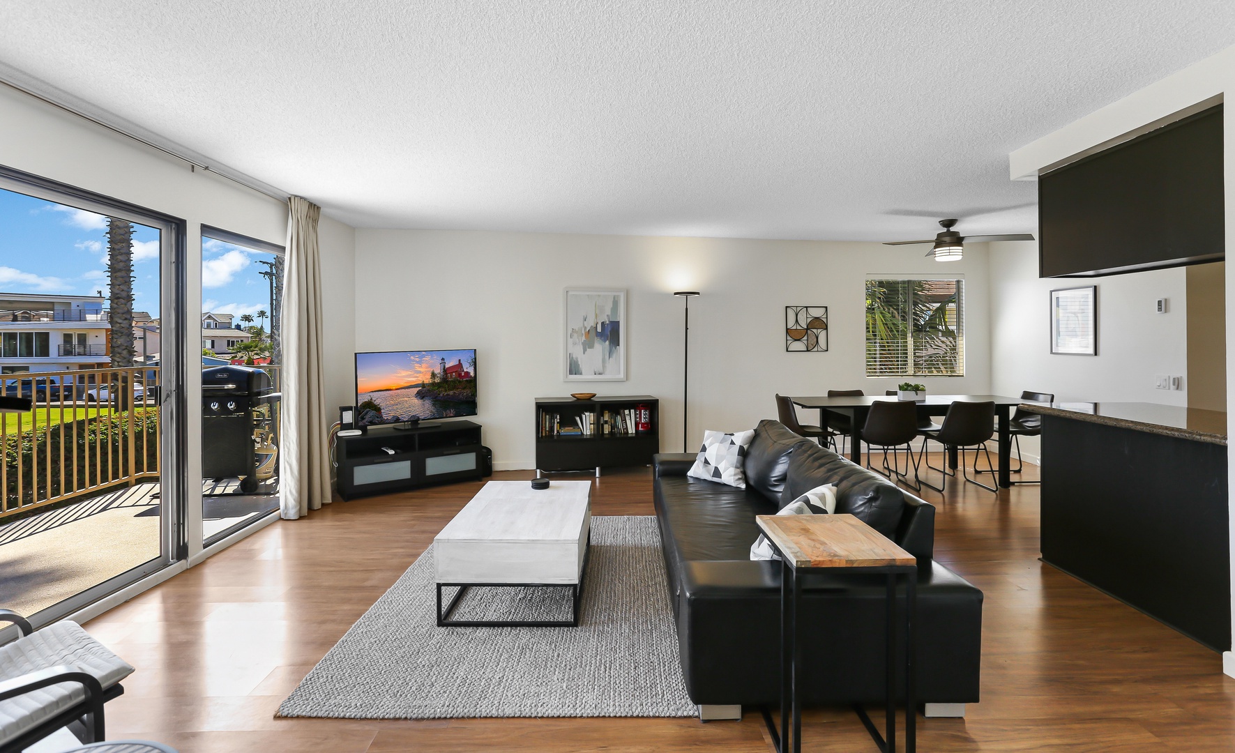 Open living space with TV, and balcony with beautiful view of Channel Park