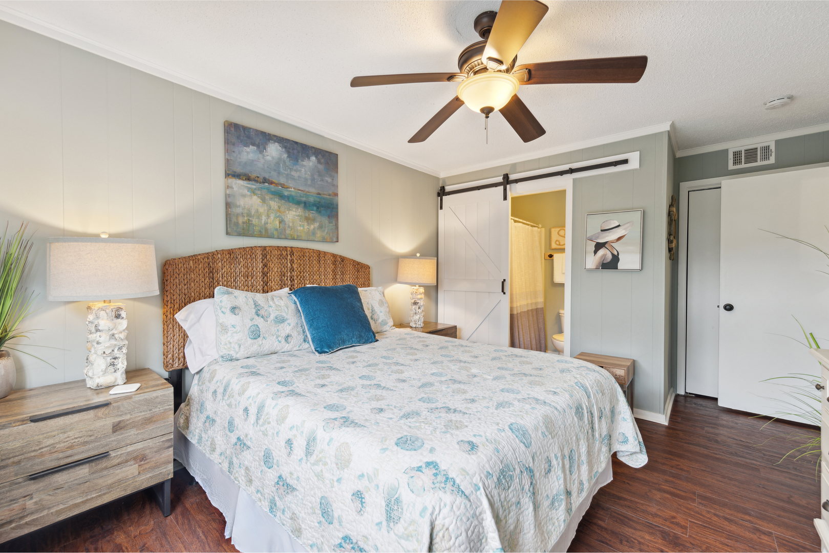The primary suite offers a queen bed, ensuite bathroom, TV, & ceiling fan