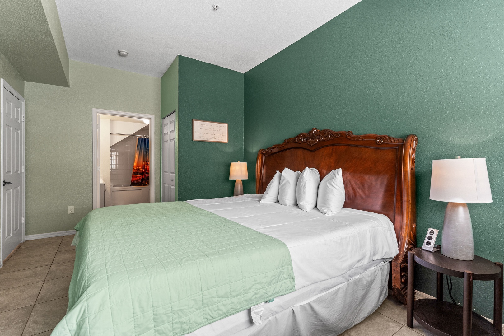 Spacious king bedroom with ensuite bathroom, smart TV, and ceiling fan