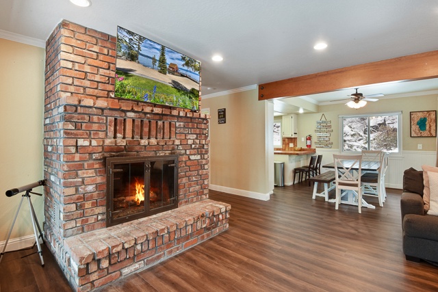Living area with fireplace, deck, and Smart TV