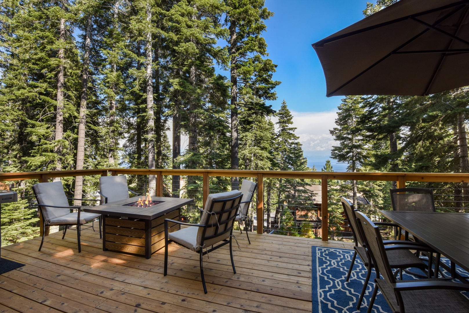 Balcony with BBQ, patio seating, and filtered lake views