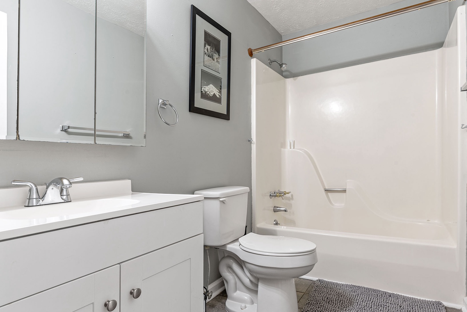 This home's full bathroom offers a single vanity & showertub combo