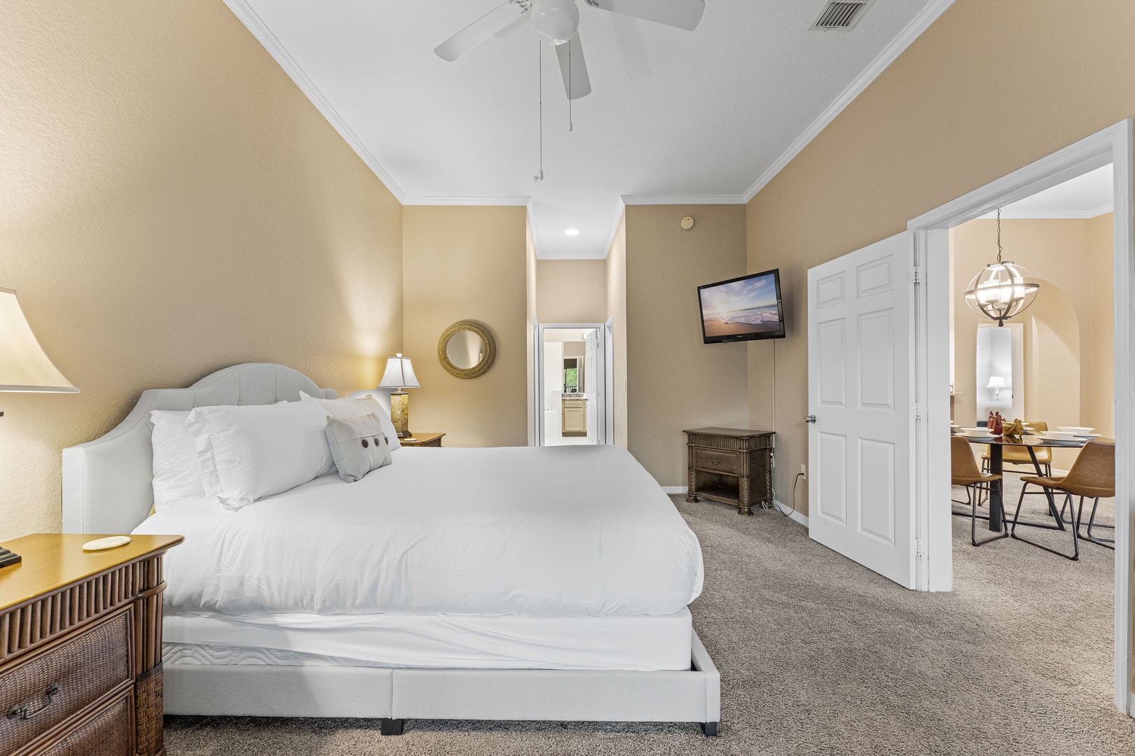 The primary king suite boasts an ensuite bath, TV, & balcony access