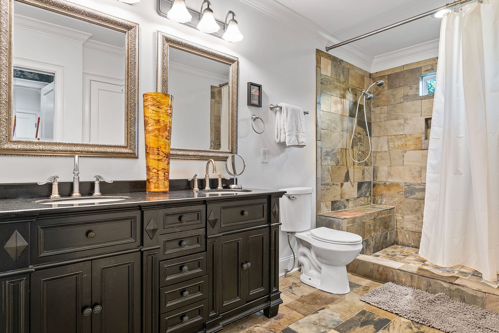 The en suite includes a double vanity & walk-in shower