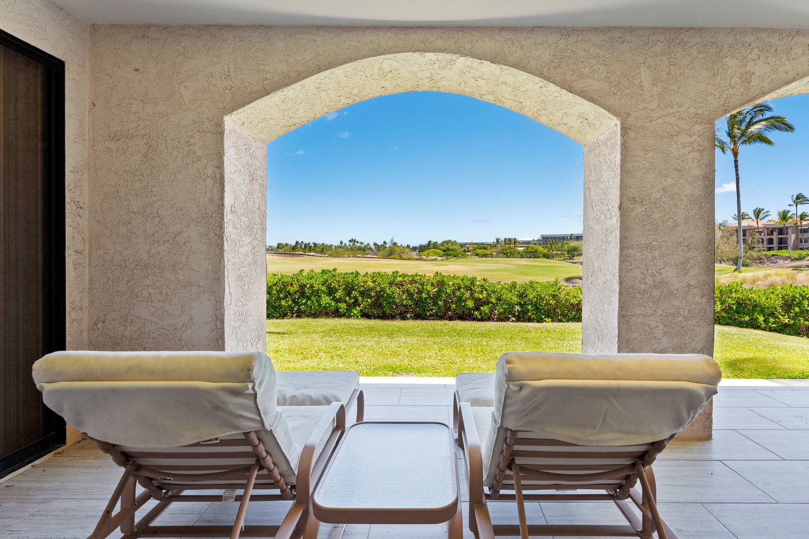 Lounge chairs on lanai with golf course views