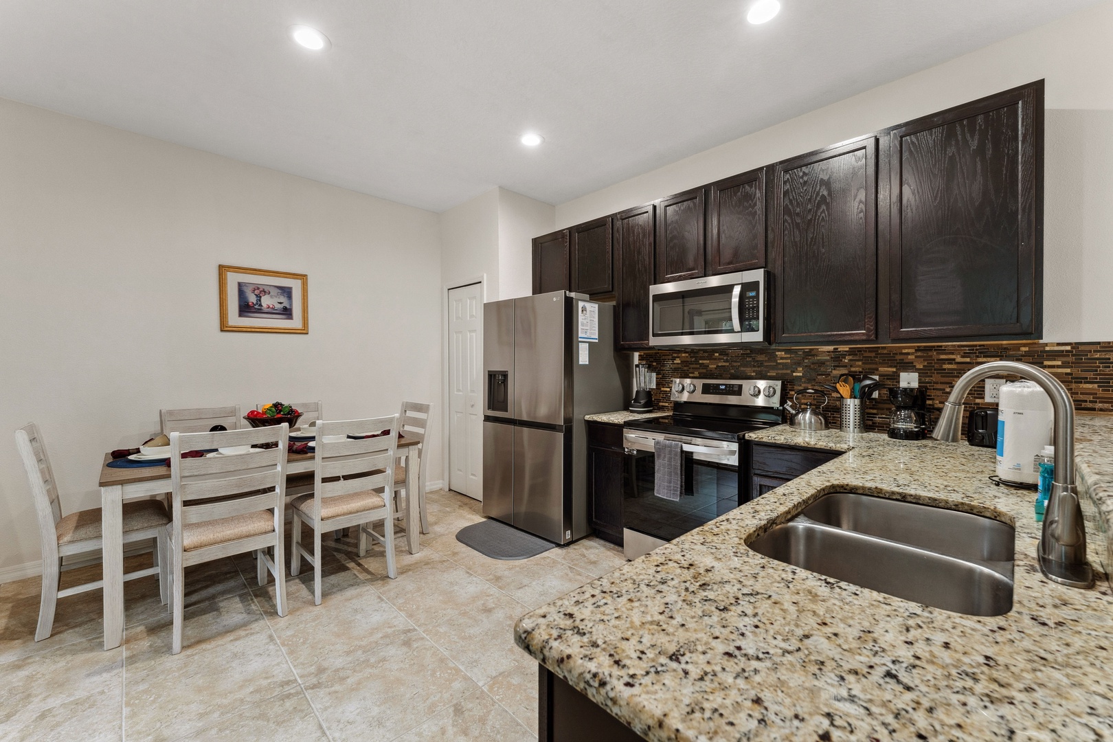 Modern kitchen equipped with stainless steel appliances and granite countertops