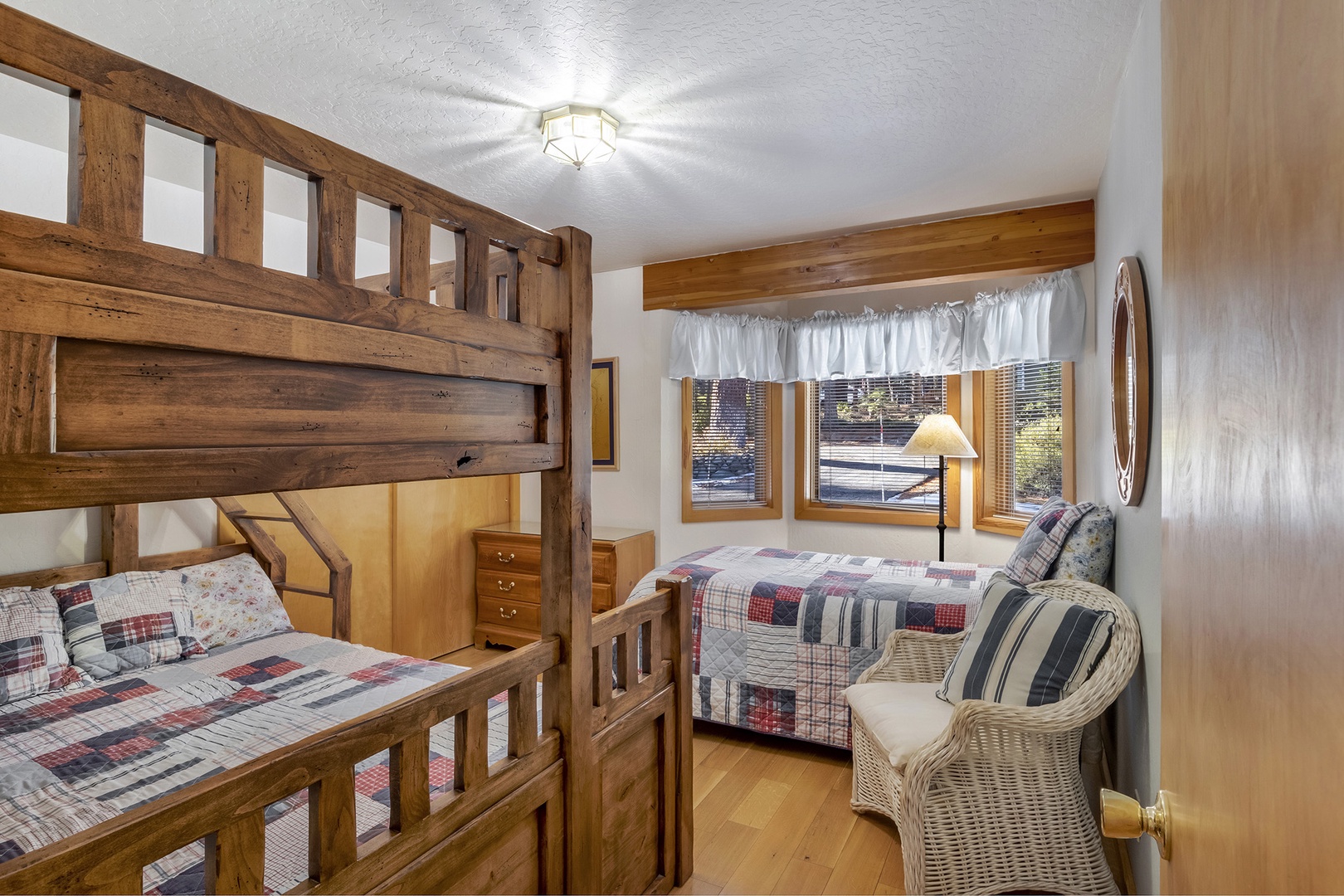 Relax in this cozy bedroom featuring a queen bunk bed and a comfortable queen bed.