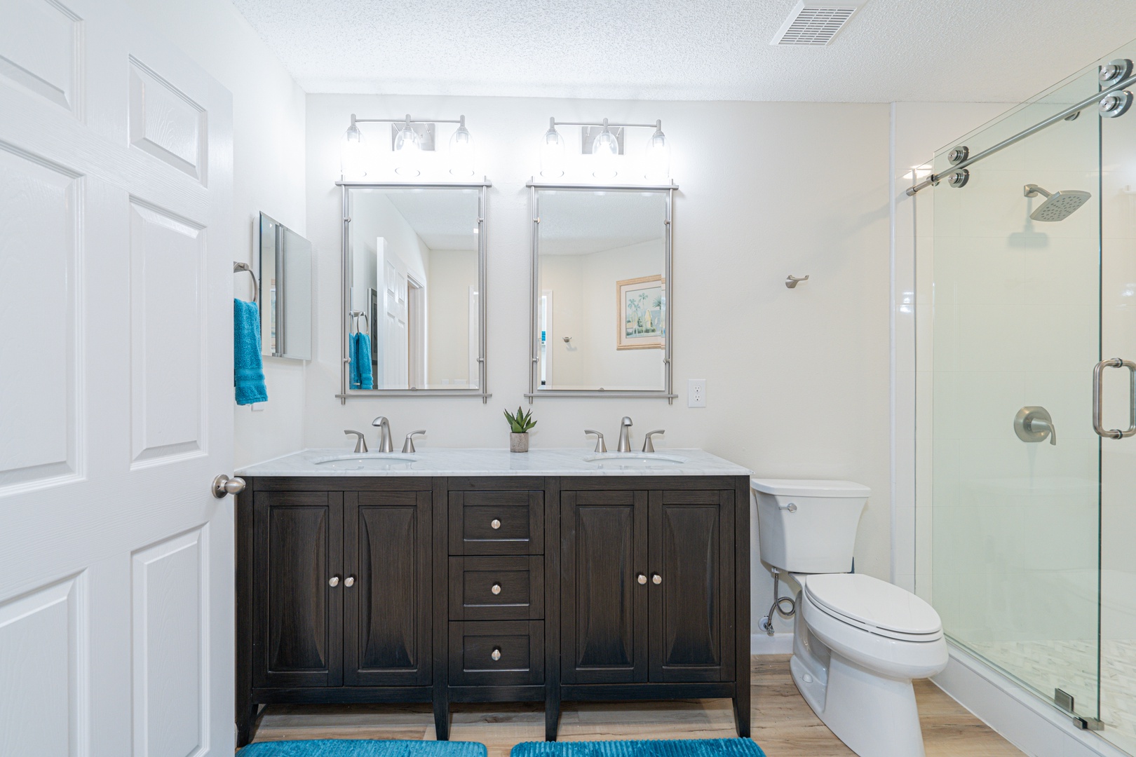 This spacious ensuite bath features a double vanity & glass shower