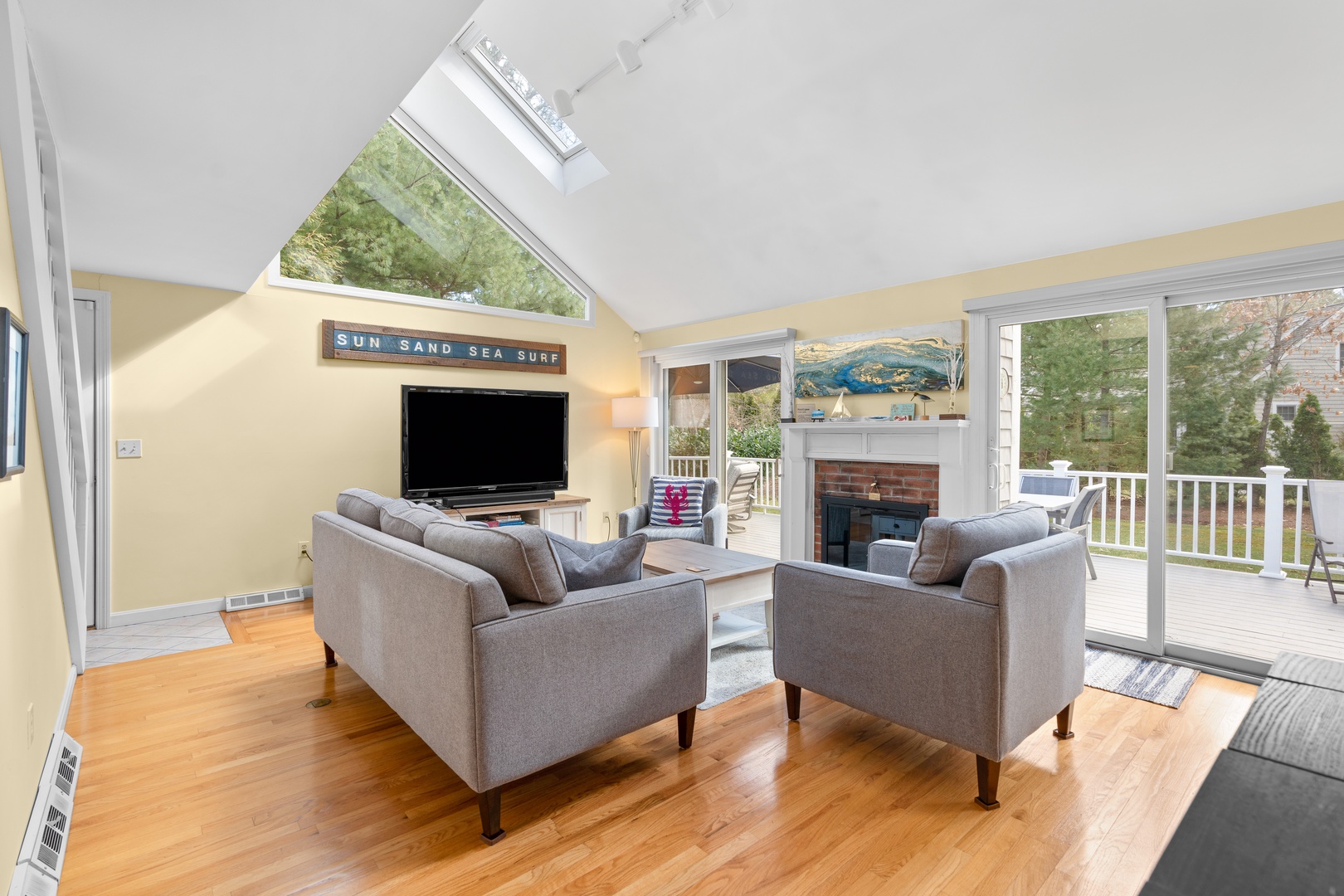Bright spacious living area with ample seating, and Smart TV