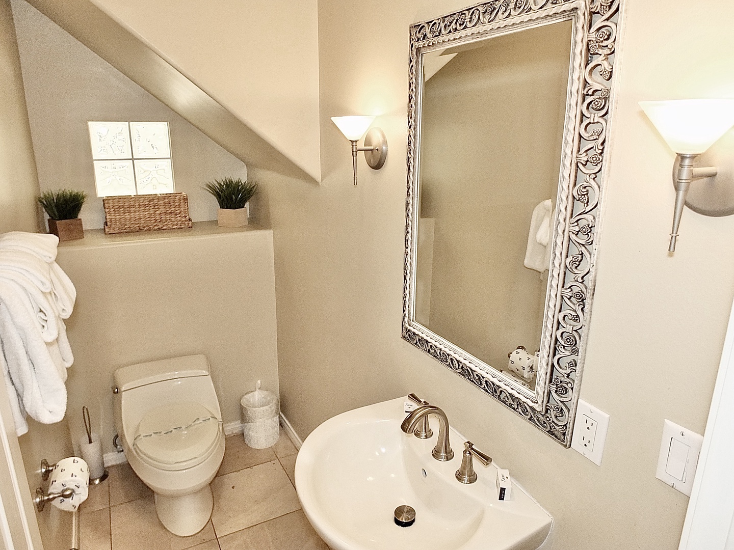 The downstairs half bathroom includes a pedestal sink