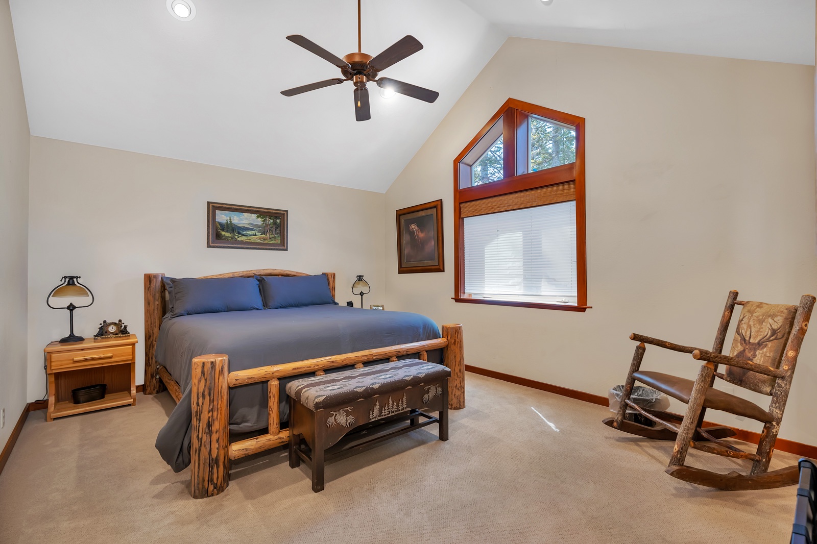 This 2nd floor king bedroom offers a sink, ceiling fan, & soaring ceilings