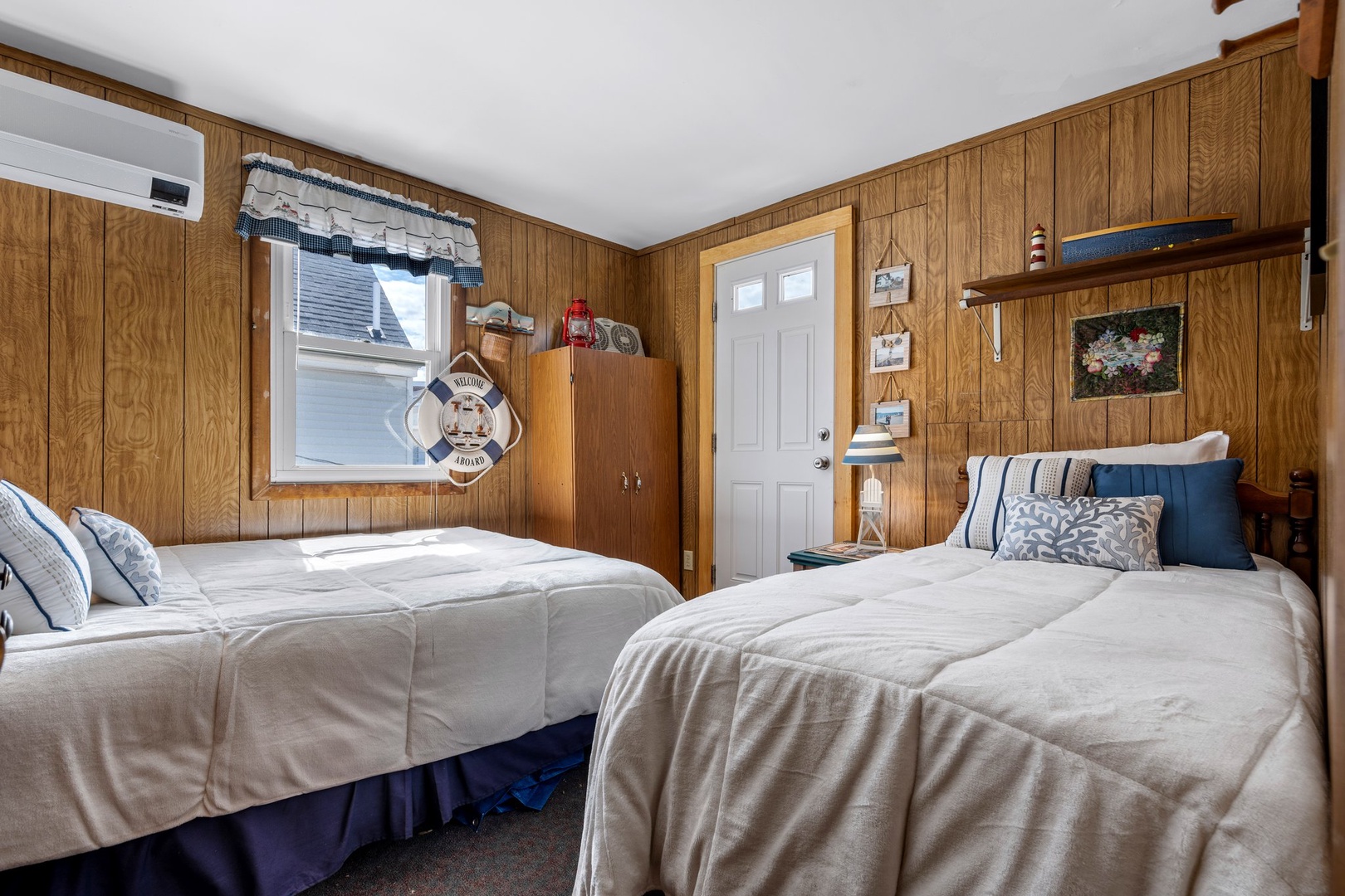 Bedroom 3 with queen bed, twin bed, and partial ocean view