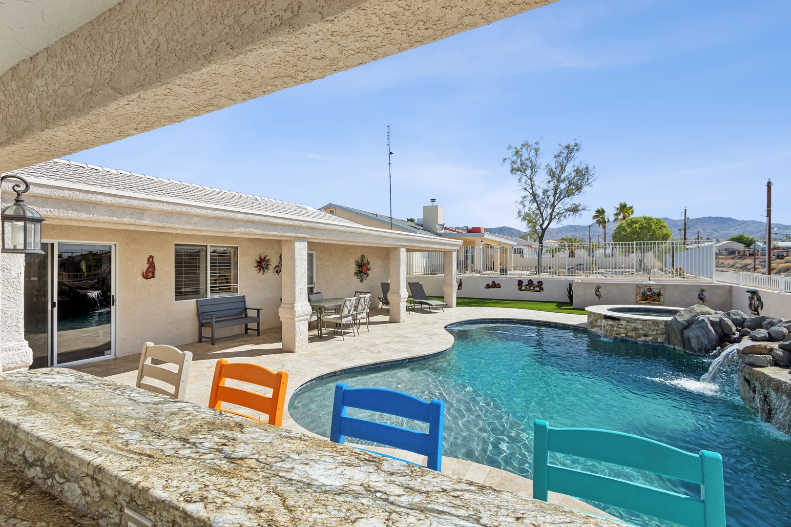 A mountain-view oasis, with a waterfall pool, hot tub, & outdoor kitchen!