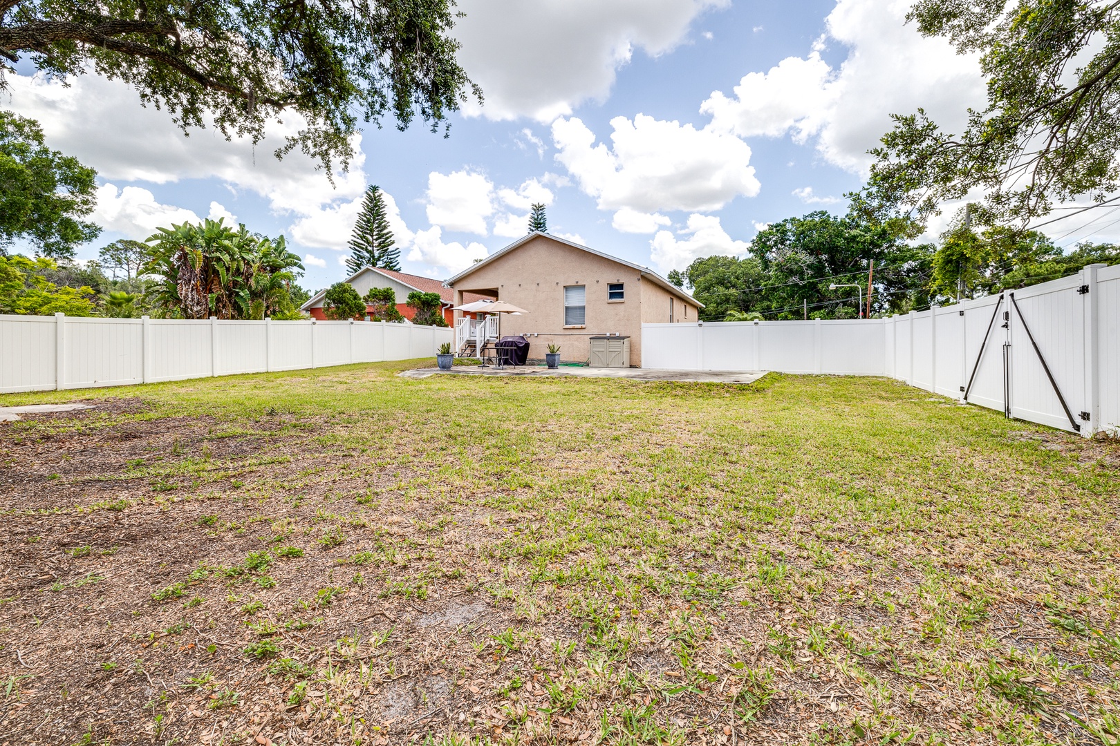 The fenced back yard offers loads of space for relaxation & play!