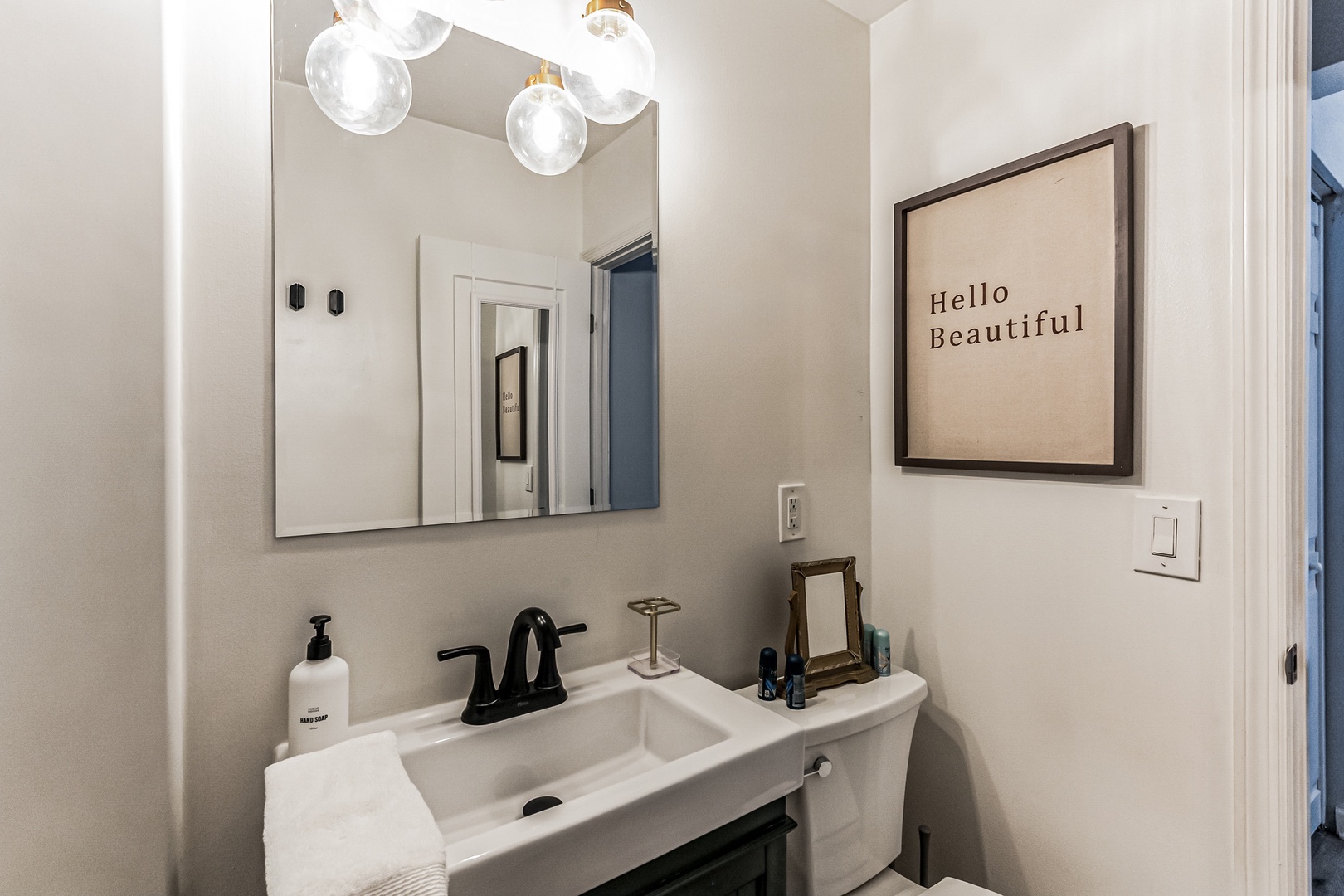 The full bathroom features a single vanity & shower/tub combo