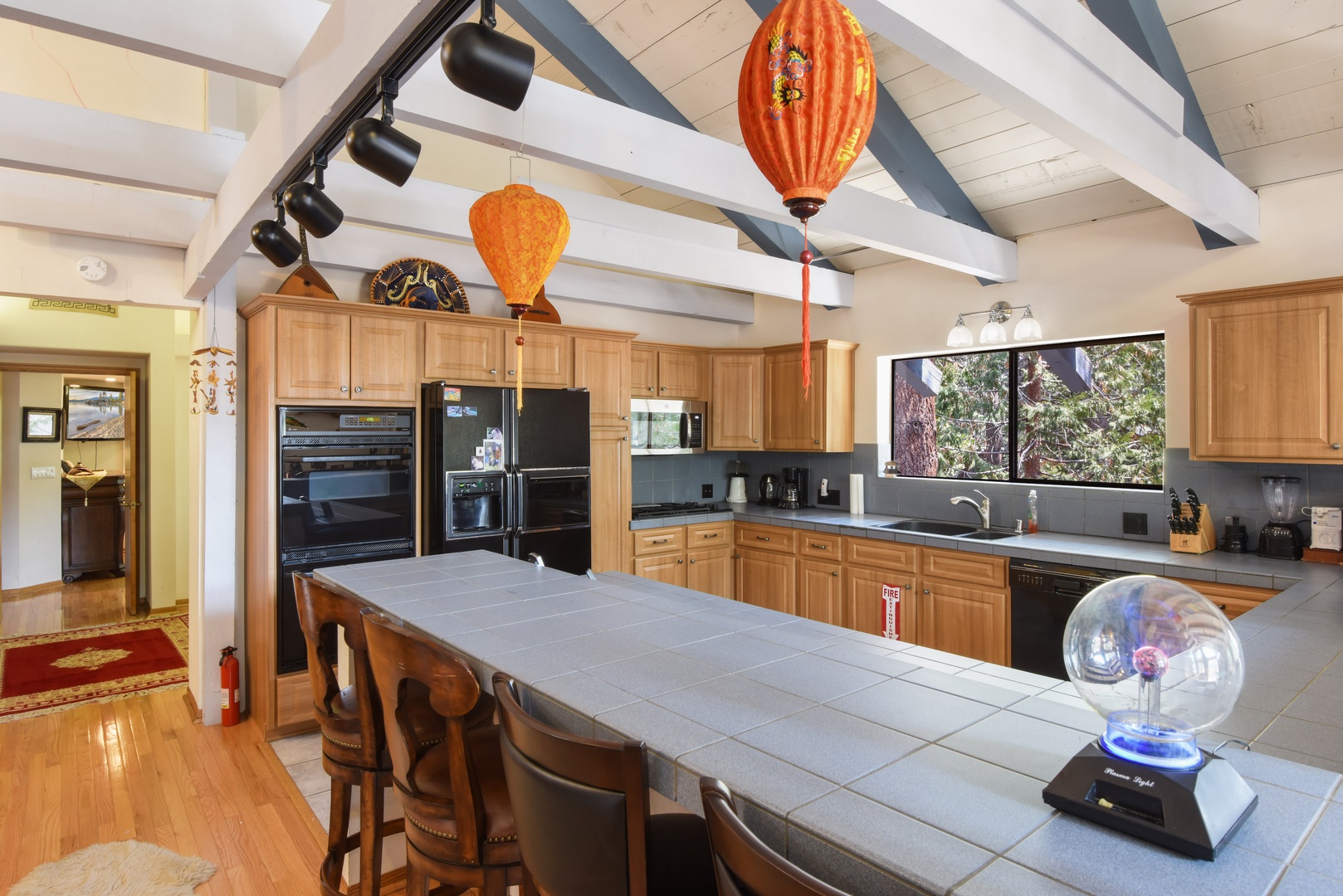 Kitchen with drip coffee maker, toaster oven, blender, slow cooker, and more